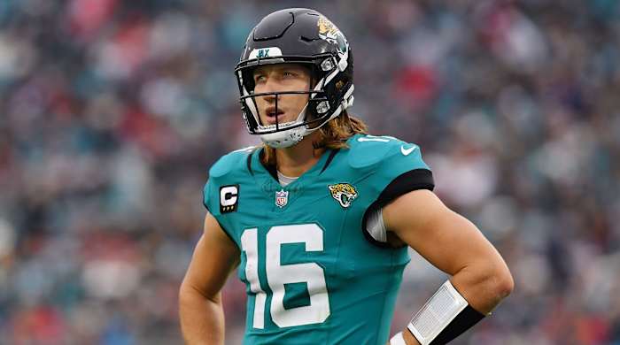 Jaguars QB Trevor Lawrence stands with his hands on his hips
